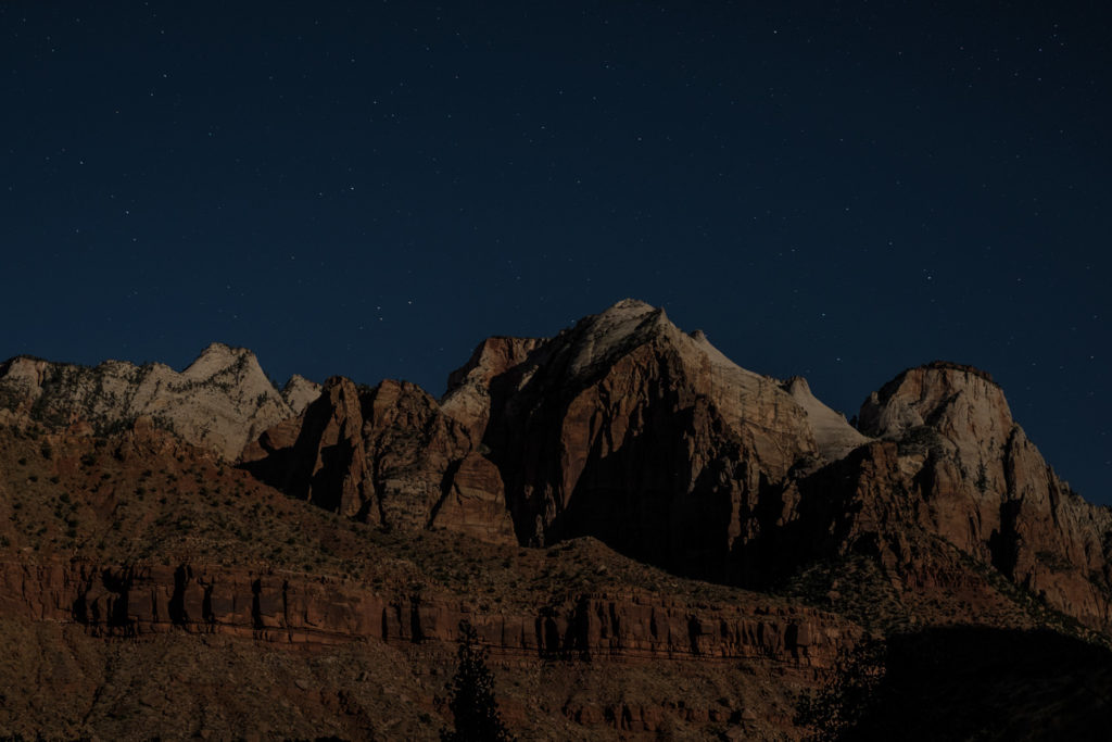 Zion mountains at night with some stars.