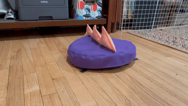 roomba in spiked dinosaur costume